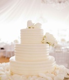 Simple Three-Layer Wedding Cake
Photography: Yvette Roman Photography
Read More:
http://www.insideweddings.com/weddings/all-white-wedding-at-a-beach-club-in-santa-monica-california/706/ White wedding cake with white roses surrounded by petals from SusieCakes