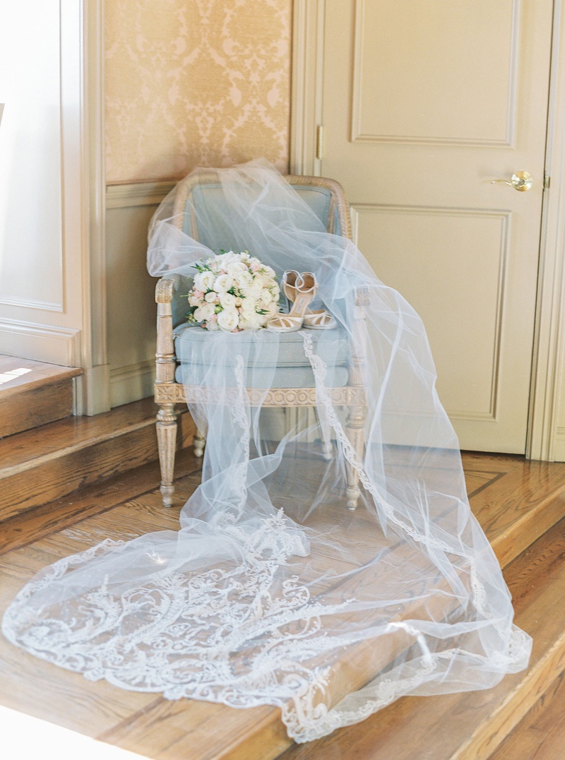 Embroidered Veil with Bouquet %26 Shoes
Photography: Lauren Fair Photography
Read More:
http://www.insideweddings.com/weddings/elegant-wedding-with-muted-regal-decor-at-oheka-castle-in-new-york/1243/ light blue antique chair beautiful veil with monogram and embroidery bouquet with high heels