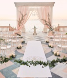 Romantic Ceremony on Patio
Photography: Binaryflips Photography
Read More:
http://www.insideweddings.com/weddings/bayfront-ceremony-garden-courtyard-reception-in-sarasota-florida/1344/ ca' d'van wedding ceremony on porch overlooking ocean, chiavari chairs in half circle, blush chuppah