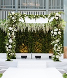 Chuppah In Front of Hedge Wall
Photography: Bob %26 Dawn Davis Photography
Read More:
http://www.insideweddings.com/weddings/classic-wedding-with-gold-details-greenery-at-library-in-chicago/1339/ indoor ceremony chicago gold chairs white aisle greenery white flowers chuppah hedge wall boxwood