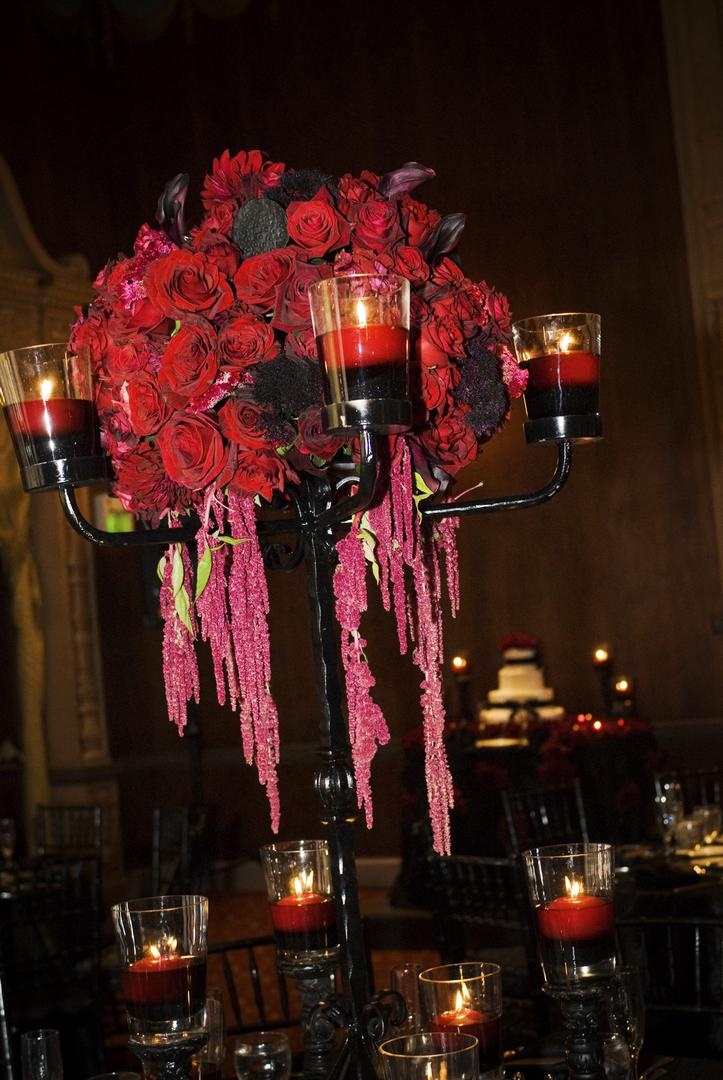 Floral Décor
Photography: Barnet Photography
Read More:
http://www.insideweddings.com/weddings/ashley-reeves-and-brandon-saller/261/ Wedding reception table with black candelabra with red candles floating in red water and red roses