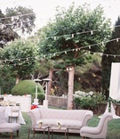 Outdoor Lounge Space Under Strings of Lights
Photography: Lane Dittoe Photography
Read More:
http://www.insideweddings.com/weddings/charming-wedding-at-california-estate-inspired-by-european-villa/817/ outdoor lounge area with tan furniture small glass coffee tables low florals under string of lights