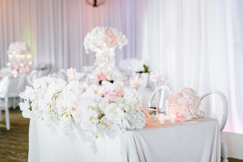 Florals Along Front of Sweetheart Table
Photography: Jodee Debes Photography
Read More:
http://www.insideweddings.com/weddings/elegant-alfresco-ceremony-reception-with-parisian-elements/1176/ sweetheart table with white linen, front of table lined with lush display of orchids and ivory roses