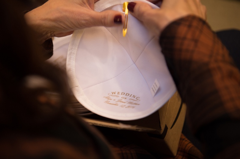 Mother of the Groom Clips Yarmulke
Photography: Carasco Photography
Read More:
http://www.insideweddings.com/weddings/jewish-wedding-with-classic-ivory-and-gold-decor-in-chicago/983/ mother of the groom prepares clip on yarmulke