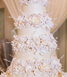 Tall Cake with White Sugar Flowers
Photography: Sarah Kate, Photographer
Read More:
http://www.insideweddings.com/weddings/traditional-catholic-ceremony-festive-new-years-eve-reception/1051/ Wedding cake opulent new year's eve wedding ivory fondant layers and sugar flowers on each tier