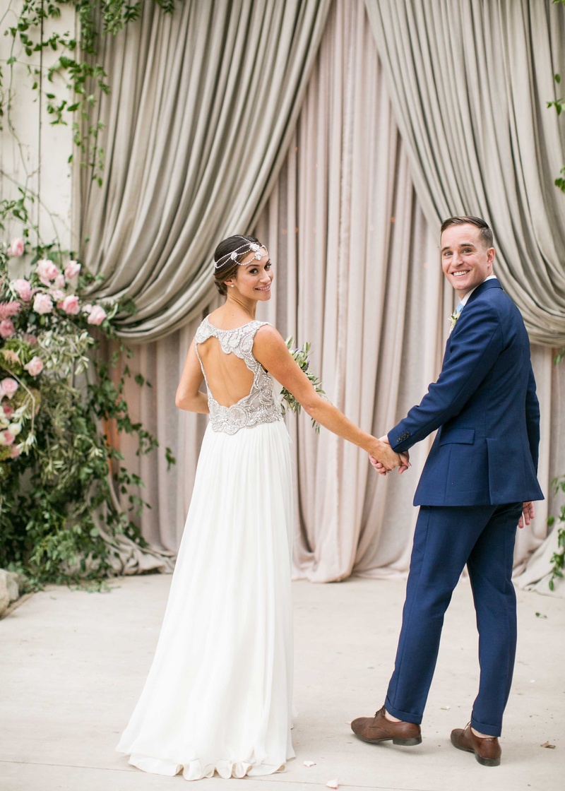 Santa Barbara Couple by Barn Venue
Photography: Samuel Lippke Studios
Read More:
http://www.insideweddings.com/weddings/a-rustic-camp-themed-outdoor-wedding/908/ Bride in keyhole back Jenny Packham wedding dress groom in navy blue suit in front of barn drapery