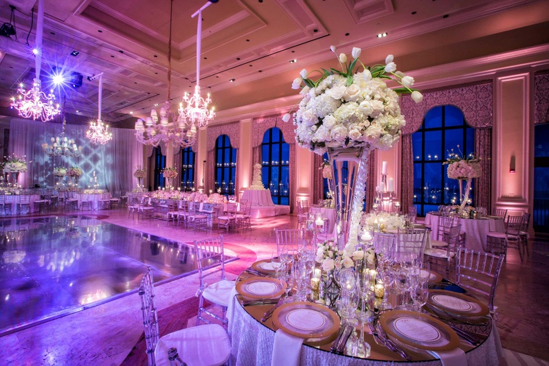 Mirror-Top Table with Tall Centerpiece
Photography: Muñoz Photography
Read More:
http://www.insideweddings.com/weddings/colorful-jewish-ceremony-ballroom-reception-at-the-breakers/818/ Wedding reception in ballroom pink violet lighting rose, tulip, hydrangea centerpiece in vase