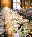 Long Table with Lush Décor
Photography: L Photographie
Read More:
http://www.insideweddings.com/weddings/church-ceremony-elegant-reception-with-silver-details/1127/ long king's table with chameleon chairs, small centerpieces and candles form