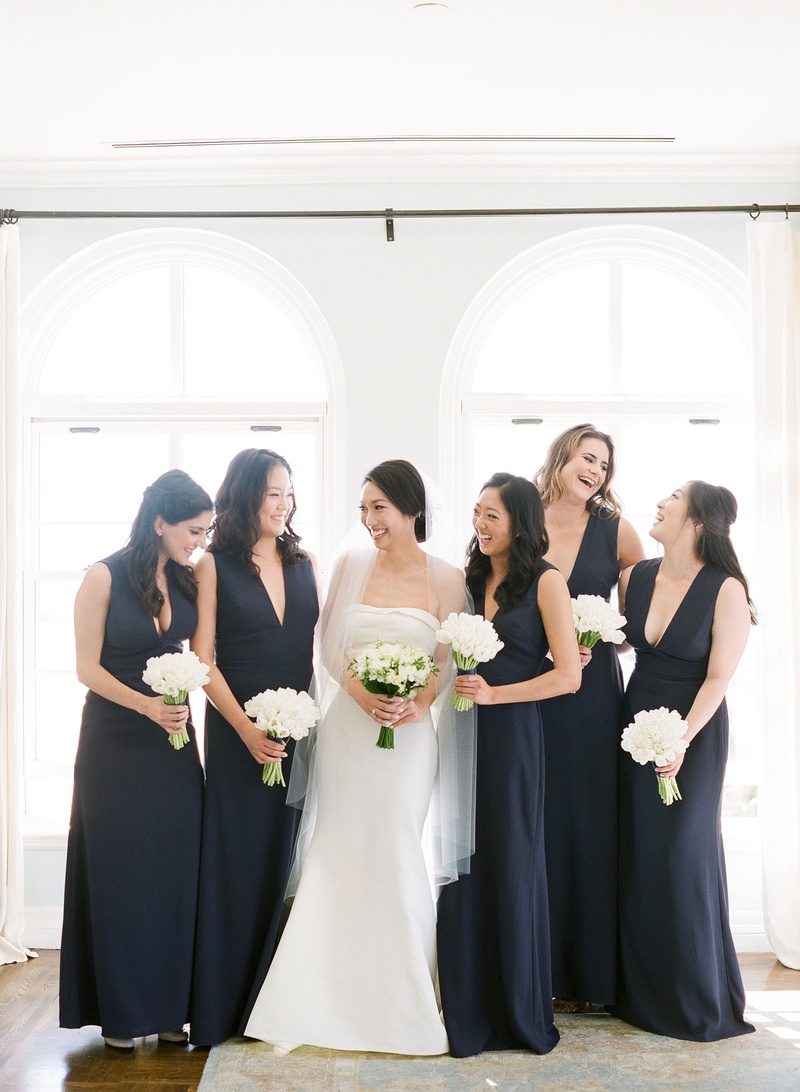 Bridesmaids in Deep-V Navy Gowns
Photography: Michelle Beller Photography
Read More:
http://www.insideweddings.com/weddings/classic-ceremony-beachfront-ballroom-reception-in-santa-monica/1234/ bridesmaids in dark navy blue plunging v-neck gowns white tulip bouquets
