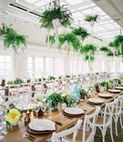 Wood Long Table with Low Arrangements
Photography: Branco Prata
Read More:
http://www.insideweddings.com/weddings/chic-destination-wedding-with-california-style-in-washington-dc/1042/ Wedding reception long table wood with white chairs ferns from ceiling low arrangements of flowers