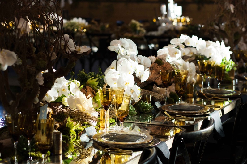 Dark, Rustic Tablescape Décor
Photography: Perez Photography
Read More:
http://www.insideweddings.com/weddings/incredible-tented-ceremony-barn-reception-at-ranch-in-aspen/860/ Mirror reception table with white orchids, colored amber glassware, honeycomb, driftwood, greenery