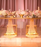 Sweetheart Table with Chandeliers
Photography: Anna and Spencer Photography
Read More:
http://www.insideweddings.com/weddings/elegant-interfaith-wedding-with-a-secret-garden-theme-in-atlanta/1178/ glass sweetheart table with gold trim and crystal chandeliers in the base