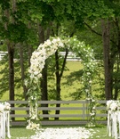Alfresco Ceremony on Groom's Farm
Photography: Images by Berit, Inc.
Read More:
http://www.insideweddings.com/weddings/tented-backyard-wedding-with-equestrian-details-at-a-family-farm/931/ Flower petals on grass lawn aisle at outdoor ceremony farm with arch greenery white flowers