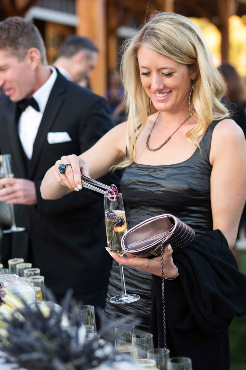 Guest Adding Garnishes to Champagne
Photography: Perez Photography
Read More:
http://www.insideweddings.com/weddings/incredible-tented-ceremony-barn-reception-at-ranch-in-aspen/860/ Wedding guest adding raspberry, blackberry, and peach to Champagne flute garnish