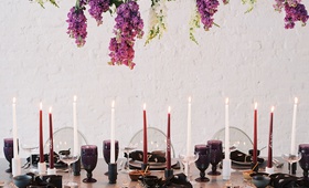 Taper Candles %26 Wisteria Overhead
Photography: Laura Gordon
Read More:
http://www.insideweddings.com/weddings/inspirational-spring-fete-with-moody-florals-modern-details/1182/ wedding reception event inspiration tablescape ghost chairs tall taper candles purple white goblets