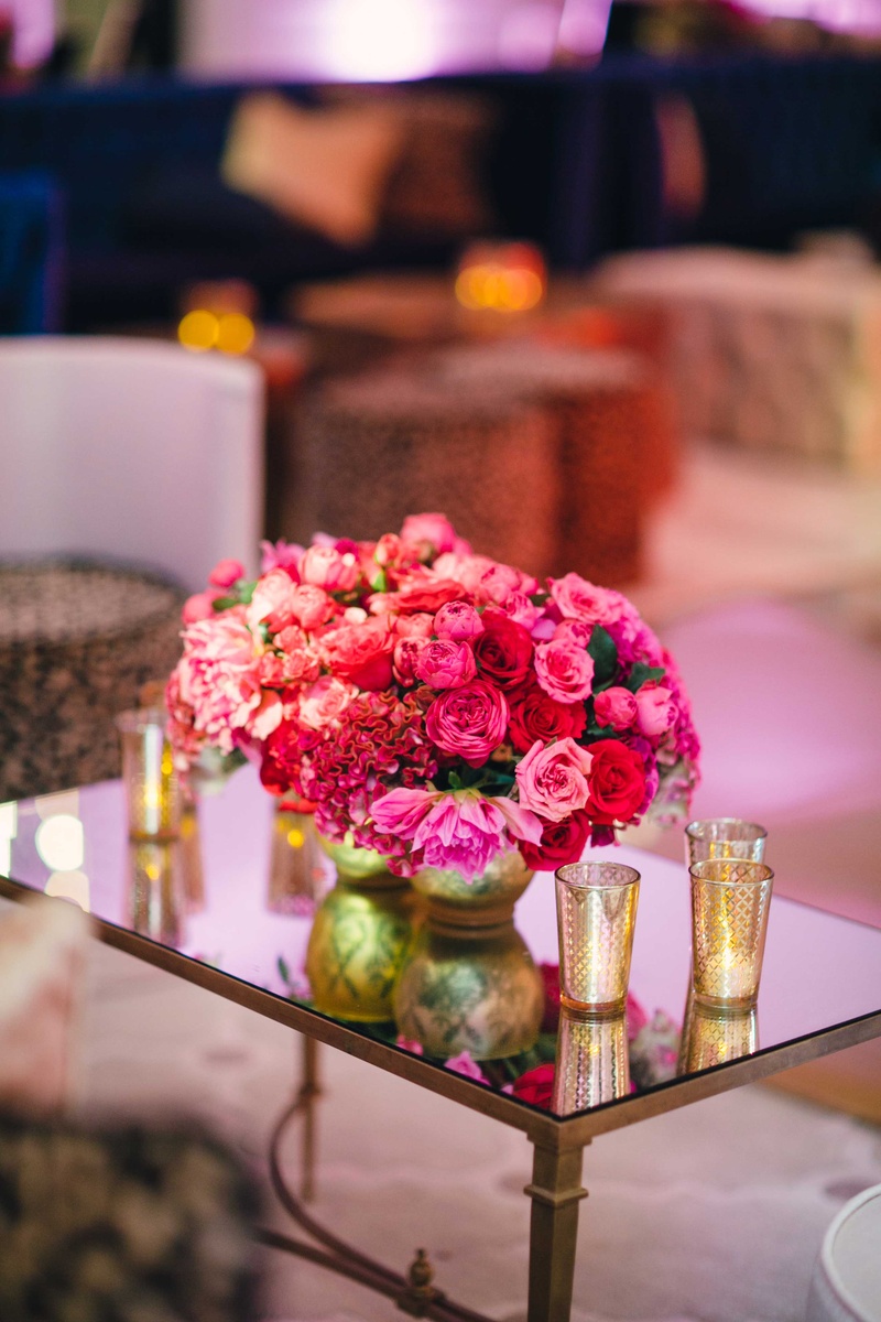 Mirror Lounge Table with Pink Arrangement
Photography: Mi Belle Photographers
Read More:
http://www.insideweddings.com/weddings/colorful-outdoor-wedding-with-supper-club-theme-in-los-angeles-ca/741/ Wedding reception lounge with mirror table and flowers pink rose, red rose, red cockscomb