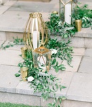 Greenery with Gold Lanterns
Photography: Kaylie Plummer Photography
Read More:
http://www.insideweddings.com/weddings/chic-alfresco-hotel-wedding-with-elements-of-modern-greenery/1350/ italian ruscus at base of unique gold lanterns