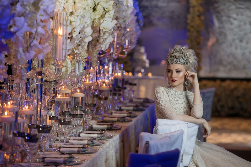 Bride Sitting in Reception Chair
Photography: Collin Pierson Photography
Read More:
http://www.insideweddings.com/weddings/winter-wedding-inspirational-shoot-with-opulent-frosted-decor/1108/ Bride with large headpiece and beaded dress sitting at white chair cover long table styled shoot