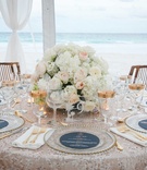 Island Wedding Tablescape
Photography: Karlisch Photography
Read More:
http://www.insideweddings.com/weddings/destination-wedding-in-pink-church-on-harbour-island-in-the-bahamas/923/ Ocean view tent wedding reception table sequins low centerpiece gold rim glasses wood chairs island