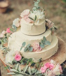 Simple Three-Layer Cake with Flowers
Photography: Pierre Torset - Paris Photographer
Read More:
http://www.insideweddings.com/weddings/elegant-outdoor-summer-destination-wedding-at-a-garden-in-france/1268/ three layer wedding cake ivory frosting decorated with greenery pink white flowers on wood stand