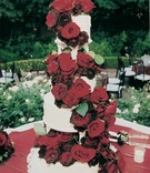 White cake covered in roses
Photography: Silvia Mautner Photography
Read More:
http://www.insideweddings.com/weddings/red-rose-inspired-backyard-wedding-in-california/42/ Red roses cascade down the sides of cake