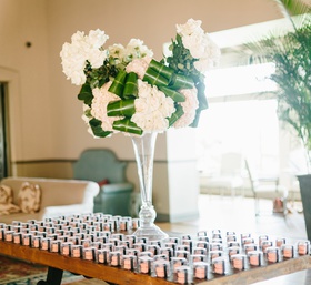 Escort Card Macarons
Photography: Jodee Debes Photography
Read More:
http://www.insideweddings.com/weddings/elegant-alfresco-ceremony-reception-with-parisian-elements/1176/ escort card table with macaron favors, floral arrangement with folded leaves