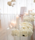 All-White Ceremony with Candles
Photography: Old South Studios
Read More:
http://www.insideweddings.com/weddings/retired-nba-player-brendan-haywoods-bold-modern-wedding/1381/ wedding ceremony aisle decorations lucite riser candles white hydrangea flowers