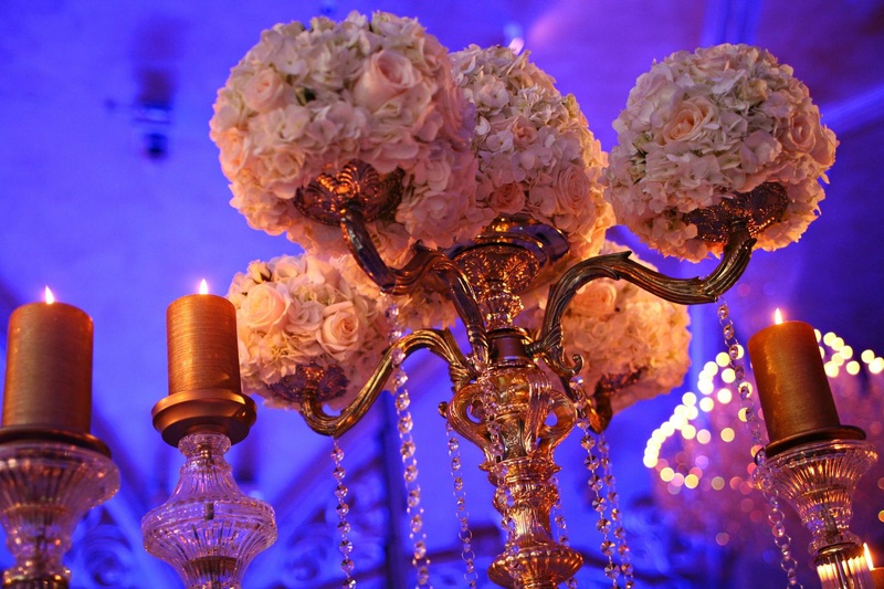 Centerpiece
Photography: Josh Lynn Photography
Read More:
http://www.insideweddings.com/weddings/purple-white-gold-new-jersey-celebration/339/ Wedding reception centerpiece of golden candelabra with light flowers surrounded by golden candles