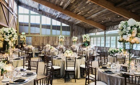 Reception Space with Angled Wood Ceiling
Photography: This Modern Romance
Read More:
http://www.insideweddings.com/weddings/rustic-chic-wedding-with-wooden-accents-and-verdant-details/861/ calamigos ranch redwood room reception, rustic wood ceiling, white and green centerpieces