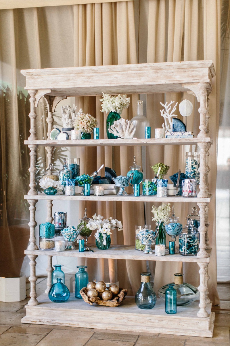 Candy Bar on Whitewashed Bookshelf
Photography: Braedon Photography
Read More:
http://www.insideweddings.com/weddings/orthodox-jewish-wedding-with-outdoor-ceremony-inspired-by-the-sea/812/ White wash wood book shelf with coral, blue vases, couple's favorite candy and desserts agate slices