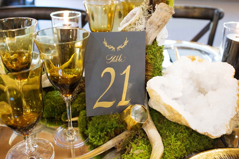 Antler Motif Table Number
Photography: Perez Photography
Read More:
http://www.insideweddings.com/weddings/incredible-tented-ceremony-barn-reception-at-ranch-in-aspen/860/ Rustic wedding with moss geode centerpiece grey table number with gold calligraphy