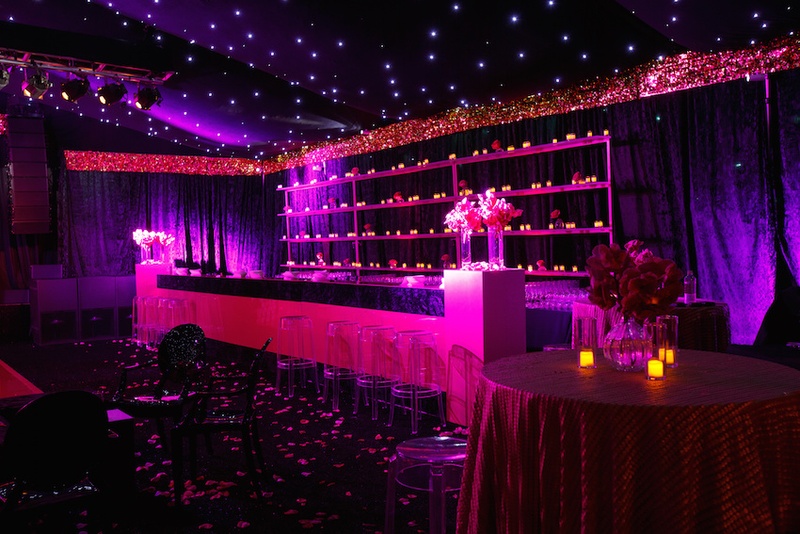 Bar at Trendy Dance Tent
Photography: Karlisch Studio
Read More:
http://www.insideweddings.com/weddings/southern-chic-wedding-in-oklahoma-with-performance-by-boyz-ii-men/697/ Wedding reception tent with twinkling lights on ceiling, bar with candlelight, violet uplighting