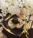 Black Napkin Rose
Photography: Kortnee Kate Photography
Read More:
http://www.insideweddings.com/weddings/glitzy-glamorous-wedding-with-black-gold-palette-in-cincinnati/1056/ black napkin rose, polka dotted plate, gold flatware