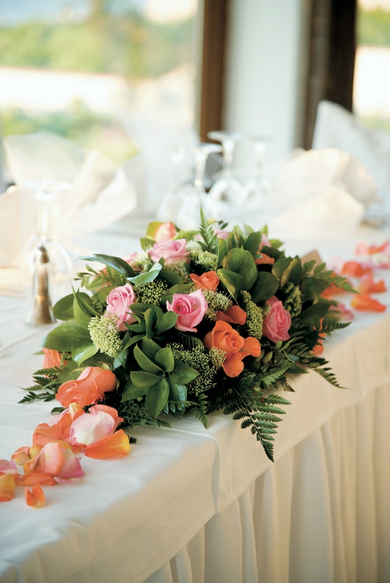 Bright Flower Arrangements
Photography: Mark Nixon Photographer
Read More:
http://www.insideweddings.com/weddings/destination-wedding-on-the-greek-island-of-santorini/207/ Colorful rose petals and flowers in greenery