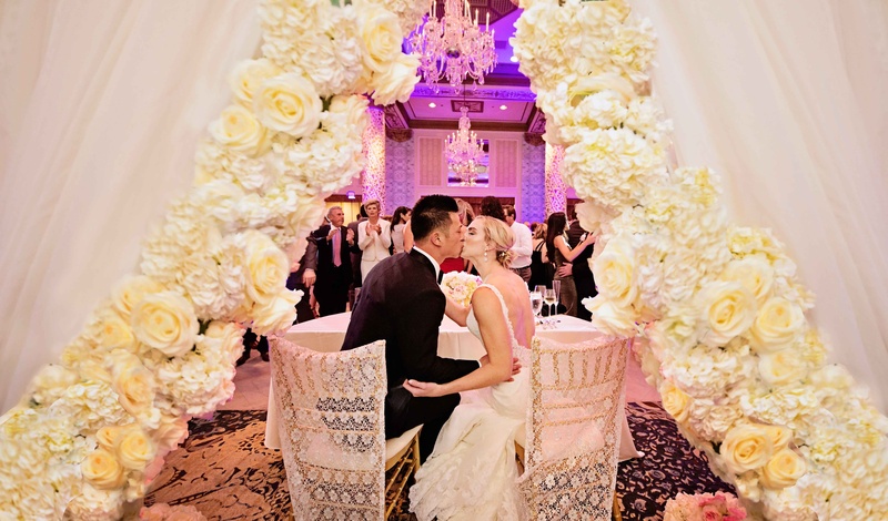 Bride and Groom Kiss at Sweetheart Table
Photography: Carasco Photography
Read More:
http://www.insideweddings.com/weddings/new-york-yankees-infielder-marries-in-opulent-chicago-soiree/764/ rob refsnyder of new york yankees kisses bride at sweetheart table with dramatic flower curtain
