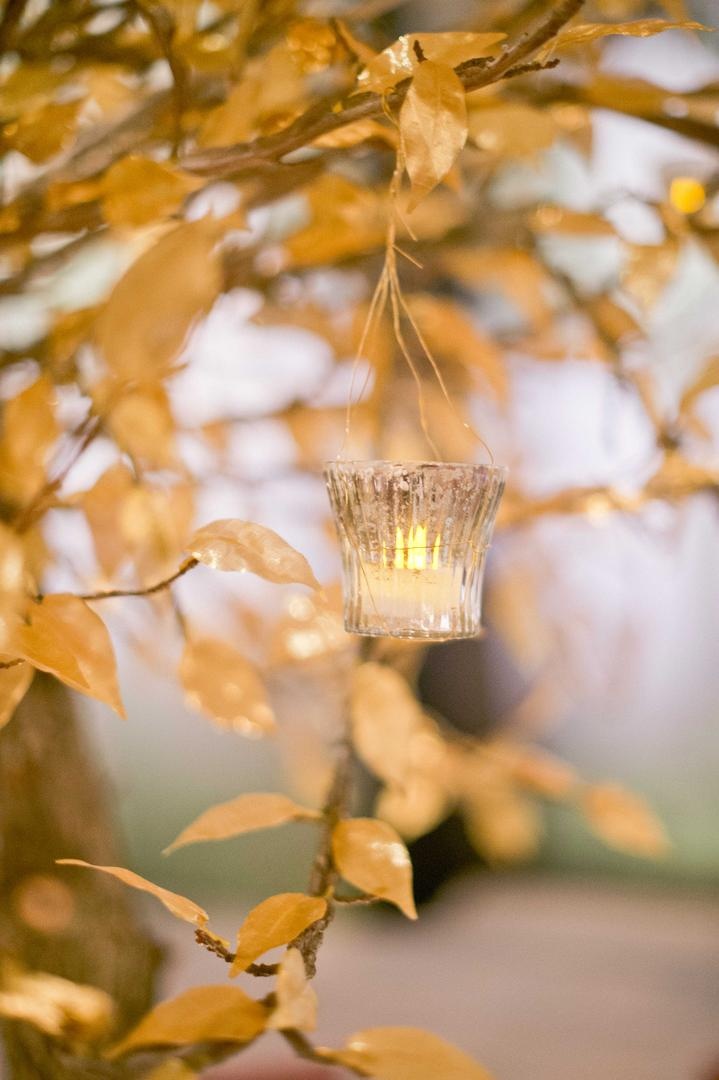Golden Tealight Centerpiece
Photography: Harwell Photography
Read More:
http://www.insideweddings.com/weddings/romantic-woodland-inspired-atlanta-wedding-with-natural-details/433/ Gold lea centerpiece with hanging votive and tea light