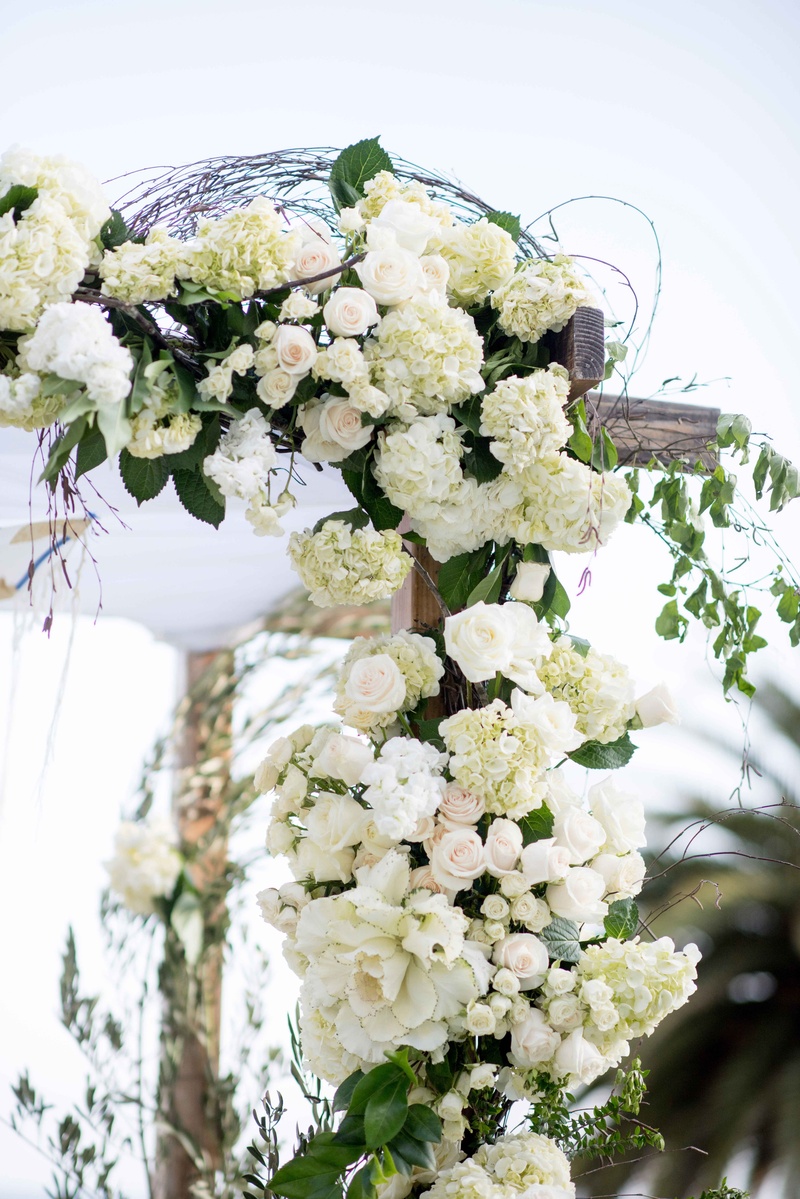 Corner of Wooden Chuppah, White Flowers
Photography: Laurie Bailey Photography
Read More:
http://www.insideweddings.com/weddings/classic-california-wedding-with-outdoor-ceremony-indoor-reception/853/ corner wooden chuppah white flowers greenery rustic seaside wedding ceremony vines