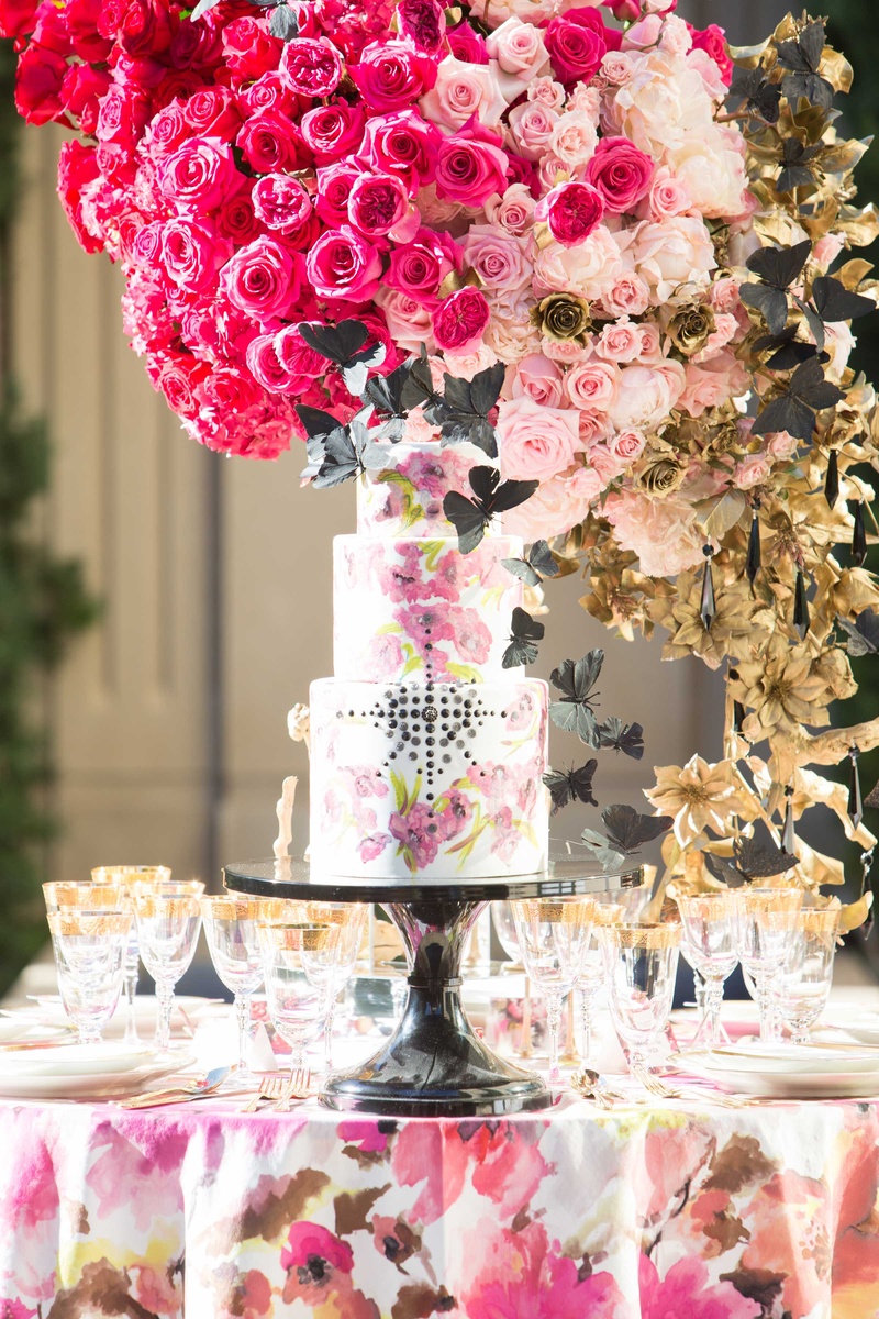 White Cake with Pink Details on Floral Table Linen
Photography: Thisbe Grace Photography
Read More:
http://www.insideweddings.com/weddings/dramatic-wedding-shoot-inspired-by-alexander-mcqueen-chanel/749/ white cake with pink flower design and black jewels black butterflies pink floral linen centerpiece