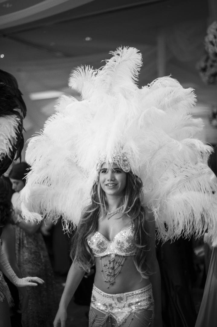 Reception Belly Dancer
Photography: Justin Marantz
Read More:
http://www.insideweddings.com/weddings/unforgettable-miami-wedding-with-acrobats-tiger-cubs-fireworks/437/ Black and white photo of feather headdress entertainer