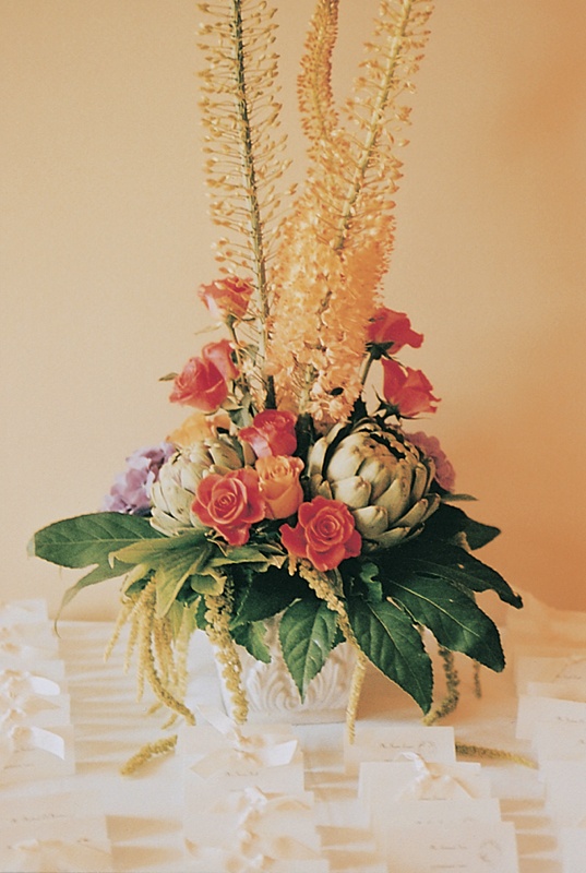 Table Card Display
Photography: Tina Carlone Photography
Read More:
http://www.insideweddings.com/weddings/mediterranean-inspired-newport-beach-wedding/39/ White table cards with bows below towering flower arrangement