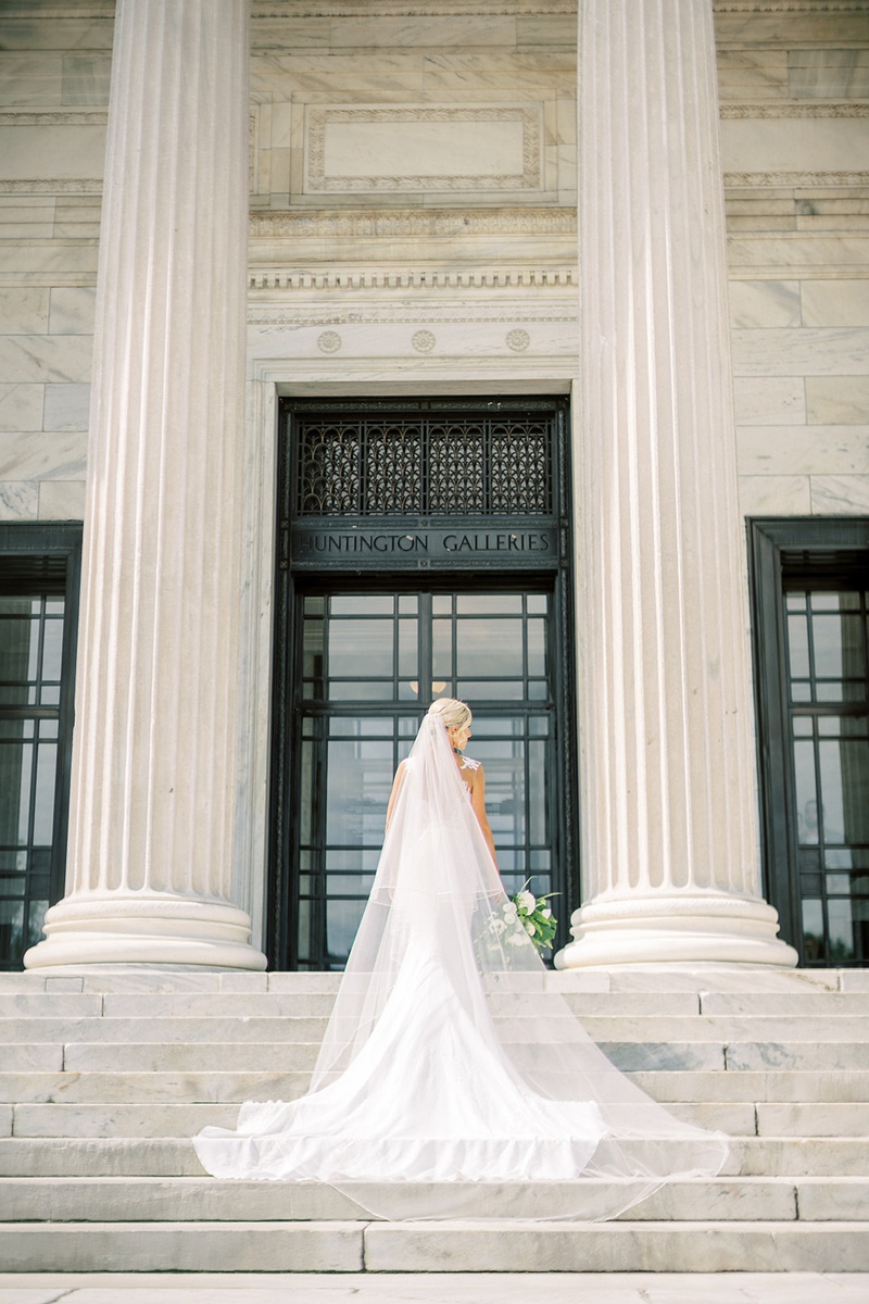 Cleveland Bride in Gorgeous Veil
Photography: Lauren Gabrielle Photography
Read More:
http://www.insideweddings.com/weddings/summer-real-wedding-featuring-tropical-decor-at-an-art-museum/1328/ bride in form fitting pronovias wedding dress wearing cathedral veil on blonde hair updo
