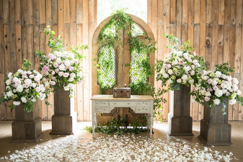 Romantic Altar in a Barn
Photography: Little Tree Studios
Read More:
http://www.insideweddings.com/weddings/brian-winters-of-the-new-york-jets-romantic-rustic-chic-wedding/1245/ rustic-chic barn wedding ceremony, floral arrangements on wooden stand, gate with greenery
