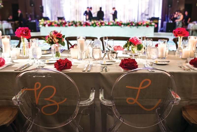 Gold Initials on Ghost Chairs
Photography: Kent Drake Photography
Read More:
http://www.insideweddings.com/weddings/bright-and-colorful-wedding-palette-with-ceremony-overlooking-lake/1315/ two ghost chairs painted in a gold initial at wedding head table