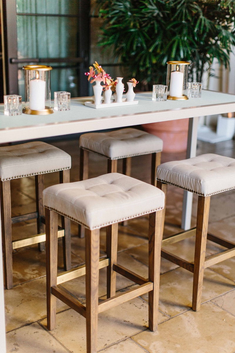 Tufted Bar Stools at Cocktail Table
Photography: Braedon Photography
Read More:
http://www.insideweddings.com/weddings/orthodox-jewish-wedding-with-outdoor-ceremony-inspired-by-the-sea/812/ white cocktail table with tufted nail head bar stools wood legs, gold candle votives, pink orchids