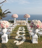 Oceanfront Wedding Ceremony
Photography: Samuel Lippke for Ira Lippke Studios
Read More:
http://www.insideweddings.com/weddings/destination-wedding-in-bali-with-eastern-western-traditions/403/ White rose petal swirl aisle at pink and white flower ceremony