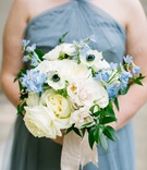Ivory %26 Light Blue Bridesmaid Bouquet
Photography: K. Thompson Photography
Read More:
http://www.insideweddings.com/weddings/traditional-ceremony-ballroom-reception-with-blue-gold-decor/1201/ bridesmaid in blue dress holding white rose anemone blue flower greenery bouquet with ribbon wrap