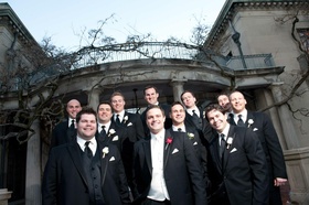 Groom In Black Tuxedo White Vest Red Rose Boutonniere With Groomsmen Tuxedos Groom In Black Tuxedo White Vest Red Rose Boutonniere With Groomsmen Tuxedos