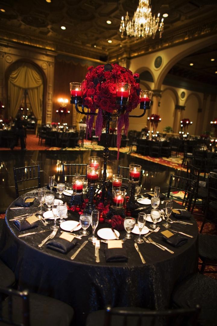 Reception Décor
Photography: Barnet Photography
Read More:
http://www.insideweddings.com/weddings/ashley-reeves-and-brandon-saller/261/ Wedding reception table with black candelabra with red candles floating in red water and red roses
