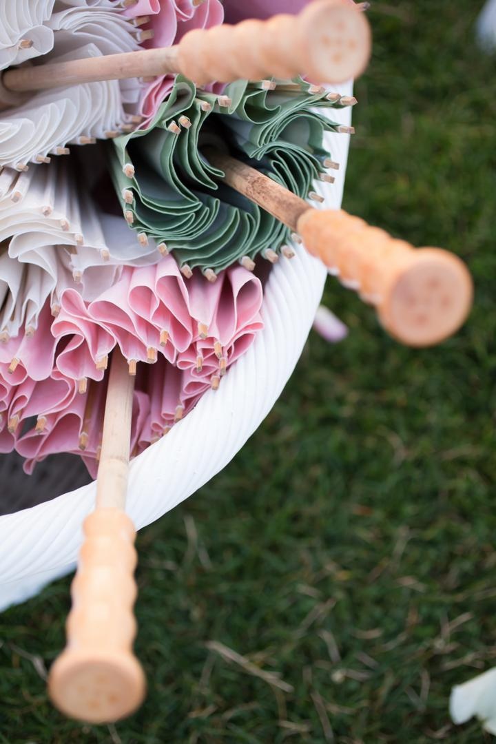 Summer Wedding Parasols
Photography: Carrie Rodman Photography
Read More:
http://www.insideweddings.com/weddings/new-england-summer-wedding-by-the-seashore/429/ White bucket filled with green, white, and pink sun-umbrellas