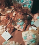 Dragée Wedding Favors
Photography: Simone %26 Martin Photography
Read More:
http://www.insideweddings.com/weddings/multicultural-winter-wedding-at-a-sophisticated-venue-in-california/75/ Blue, pink, and white jordan almonds in gold and brown sheer bags